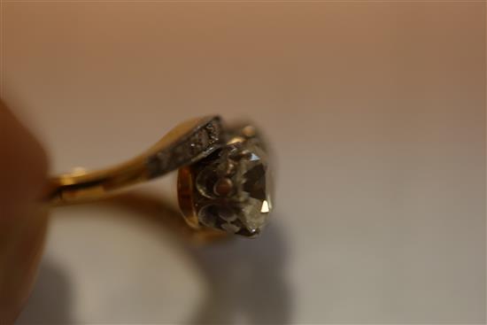A gold and platinum, two stone diamond crossover ring with diamond set shoulders, size P.